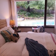 bed with view of swimming pool